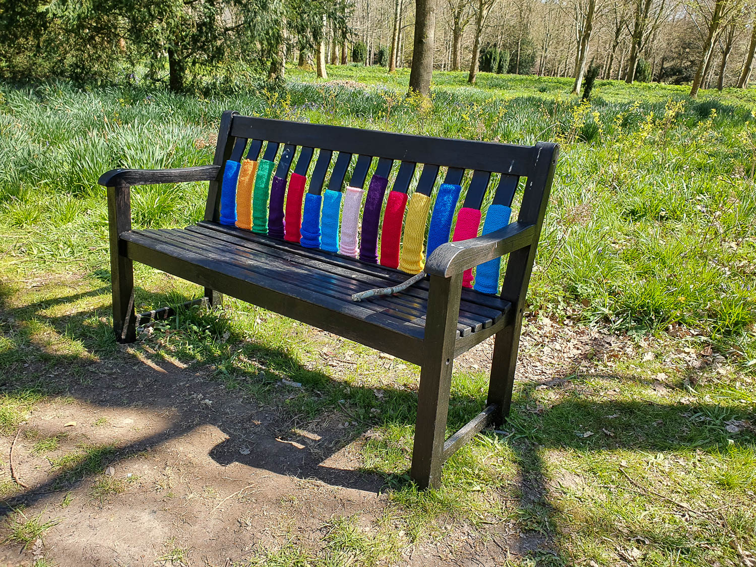 Yarnbombed bench in the gardens at Petworth National Trust in Sussex