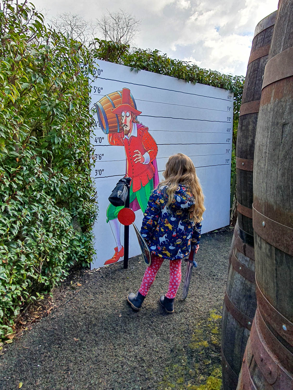 My daughter looking at a height chart showing one of the Gunpowder Plot conspirators in the Horrible Histories Maze at Warwick Castle