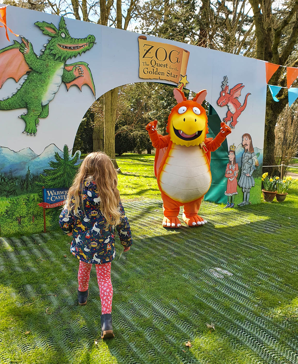 My daughter walks towards Zog the dragon at the end of Zog and the Quest for the Golden Star trail at Warwick Castle - my review of the Warwick Castle Zog trail