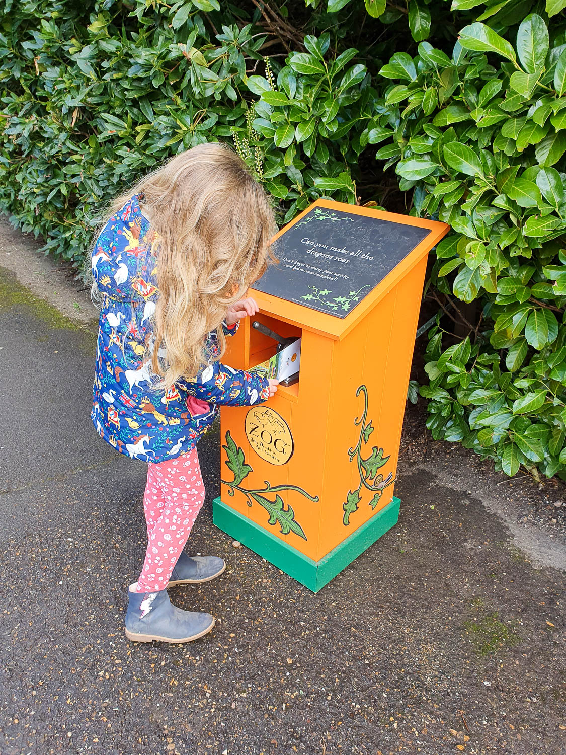 My daughter stamping her trail card for the Zog trail at Warwick Castle - my review of the Warwick Castle Zog trail
