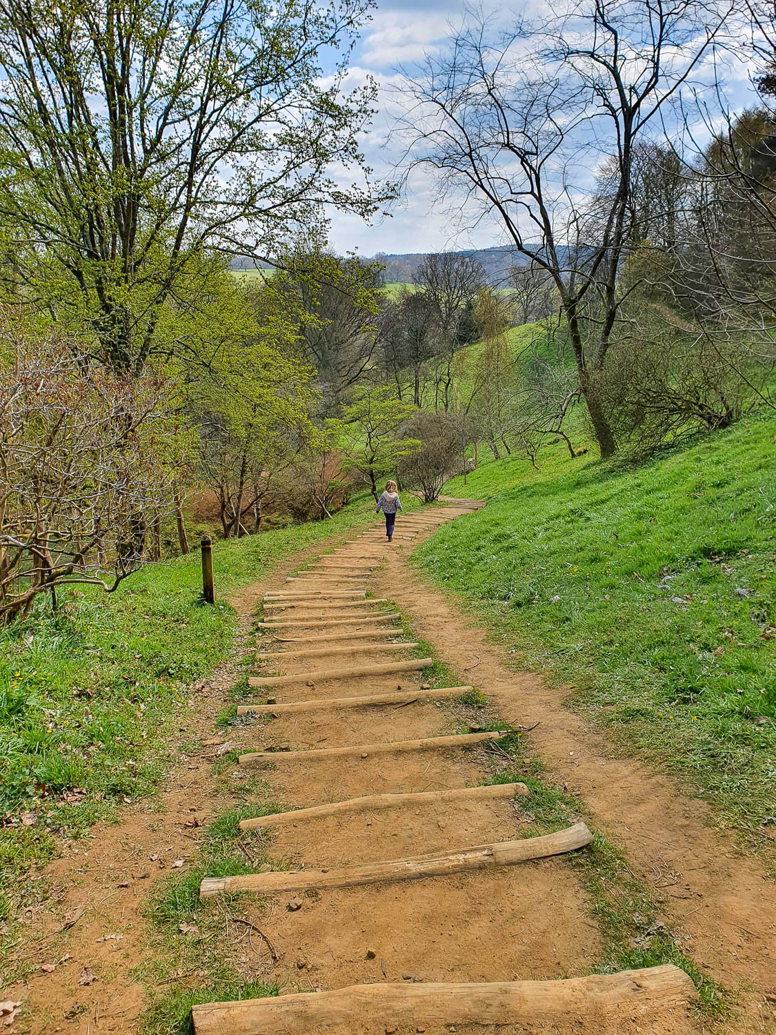 My daughter on the steps down the hillside at Winkworth Arboretum in Surrey - a day out at Winkworth National Trust with kids