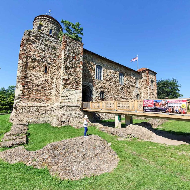 My daughter stands on part of the ruins of the Temple of Claudius in front of Colchester Castle, one of my top things to do in Colchester with kids
