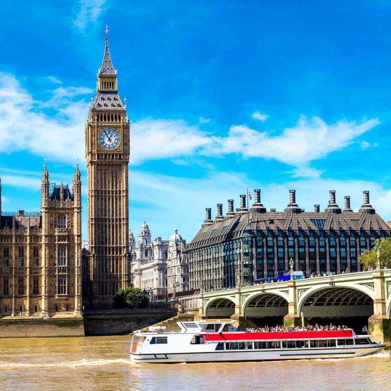 Open-topped boat sailing towards Westminster bridge with the Houses of Parliament and the tower containing Big Ben in the background - my pick of the best boat tours in London with kids