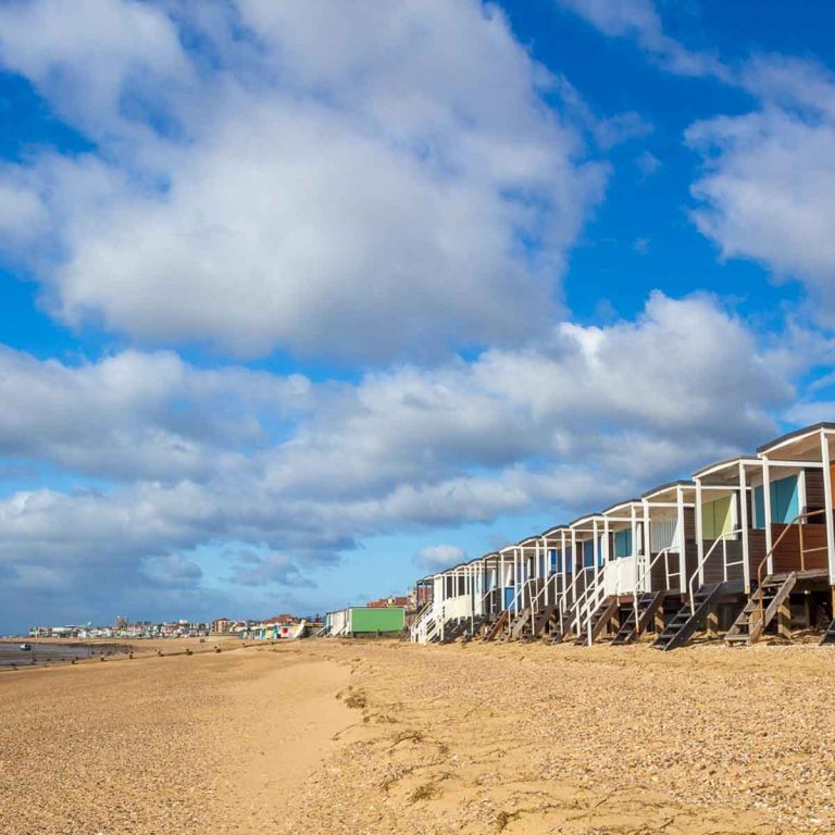 Beach huts at Thorpe Bay Beach, Essex, England on a sunny day - ideas for the best beaches and other great things to do in Essex with kids