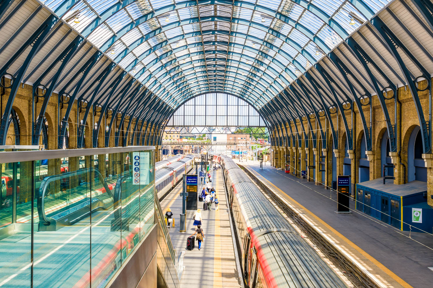 View of platforms at Kings Cross station in London, looking down at the trains under the curved glass roof - my top day trips from London with kids, all of which can be done by train