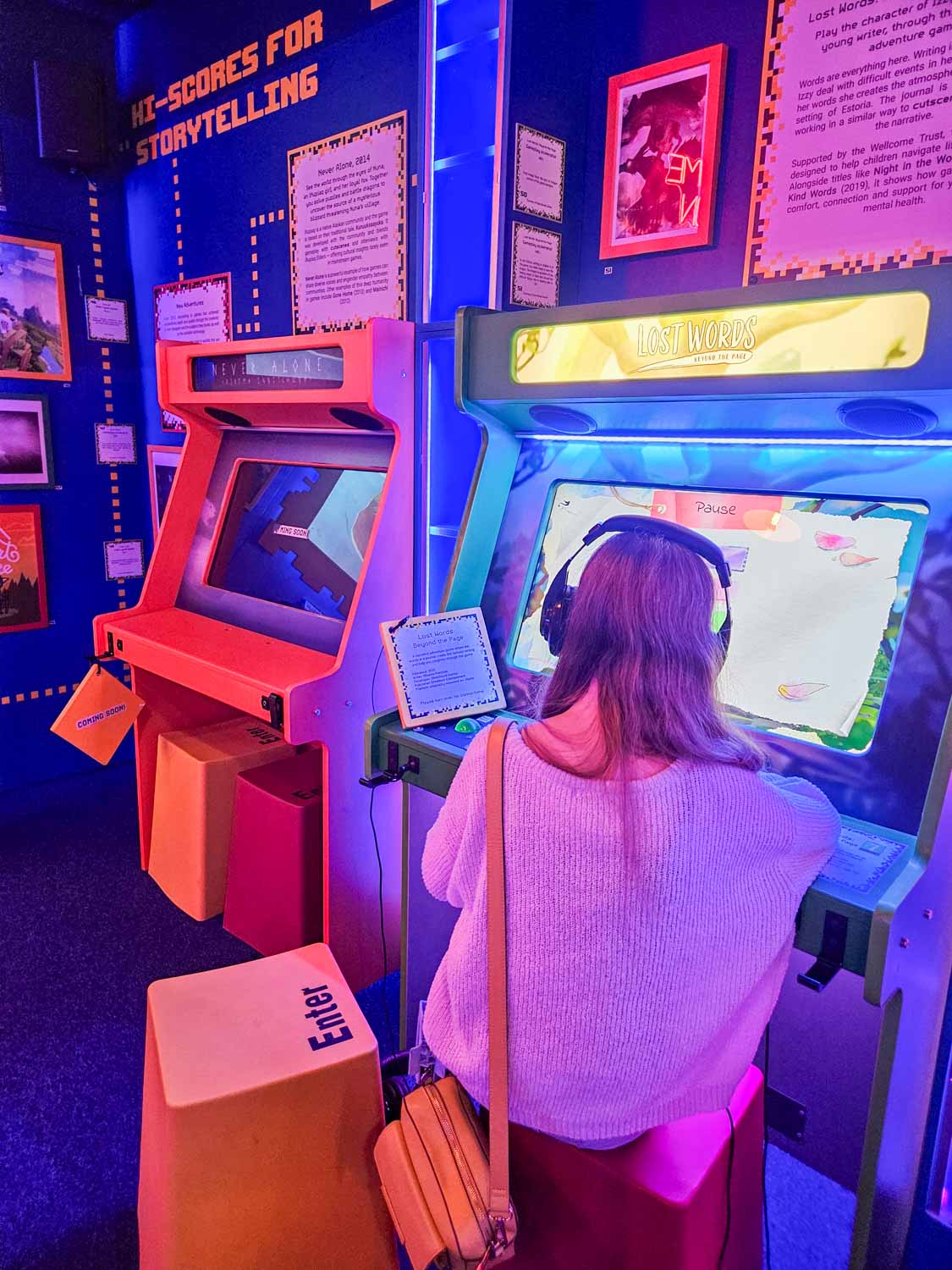 My daughter sits at one of the old arcade machines in Story Arcarde during a visit to the Story Museum in Oxford