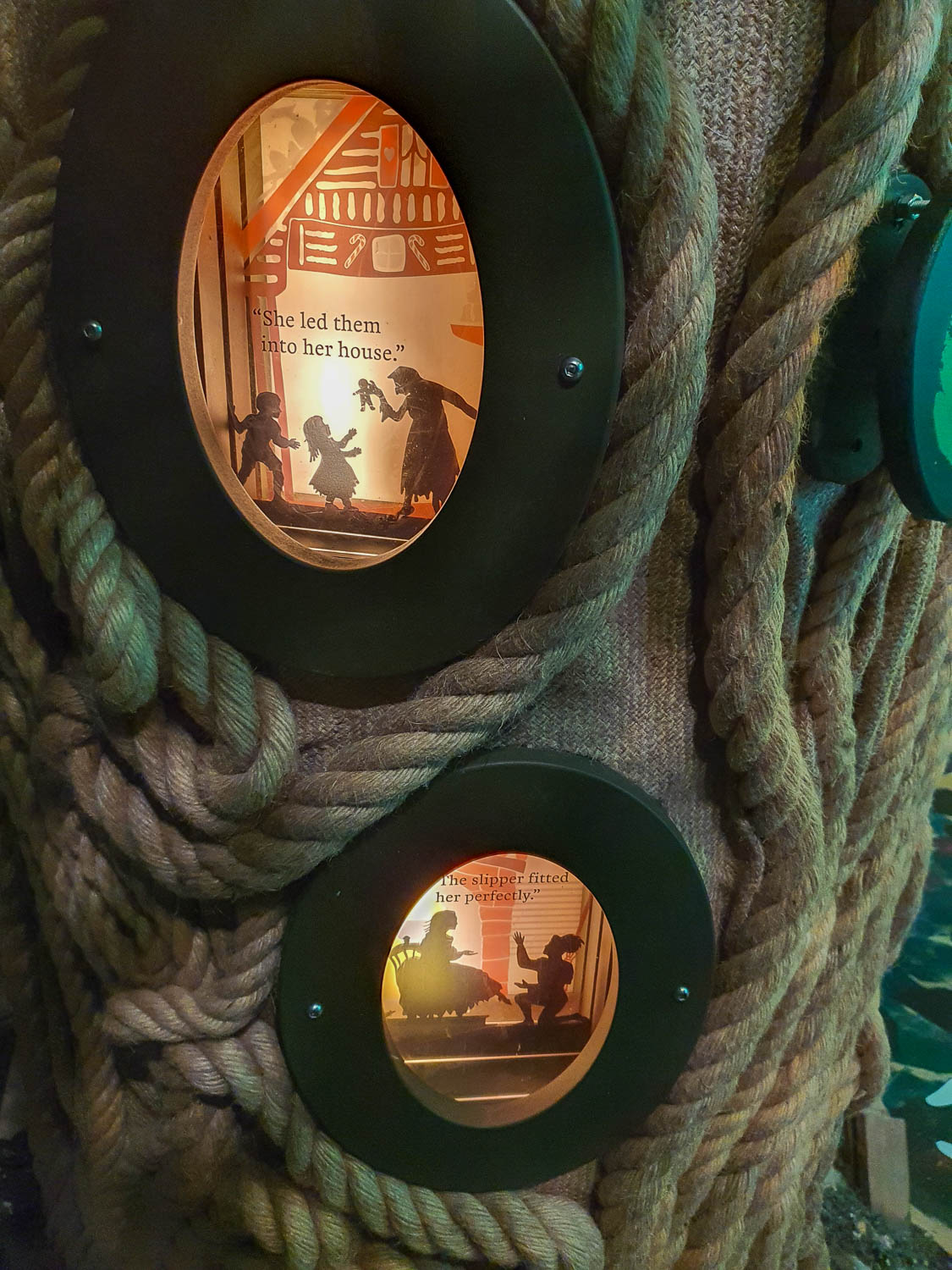 View of two images with scenes from Grimm's fairytales in a rope tree in the Whispering wood during our Oxford Story Museum review visit