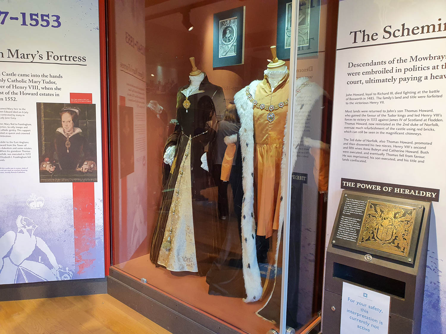 Two grand medieval outfits on display at Framlingham Castle during a day out in Suffolk with kids