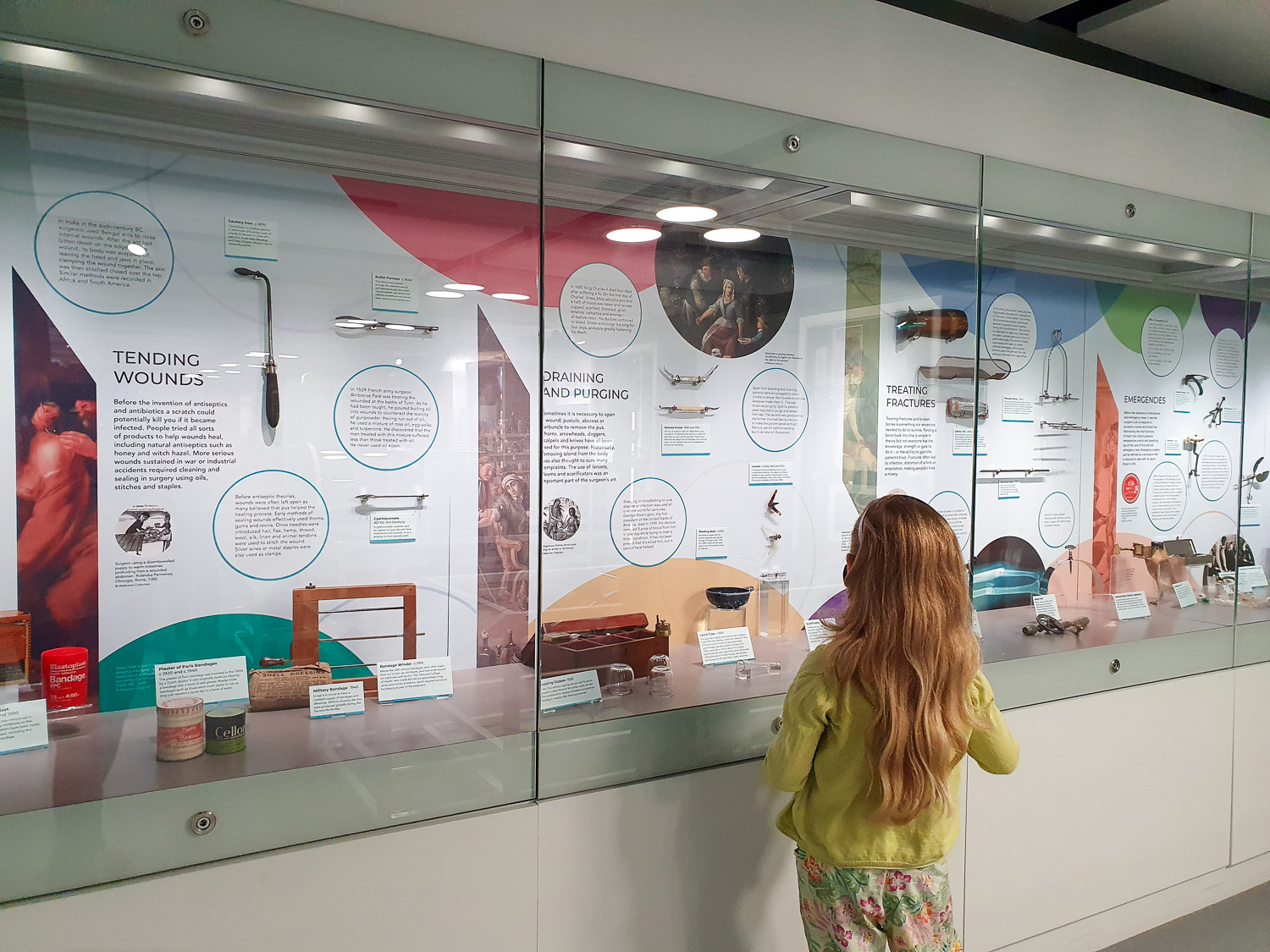 My daughter looks at glass cases containing medical tools from over the centuries at the Thackray Museum, Leeds