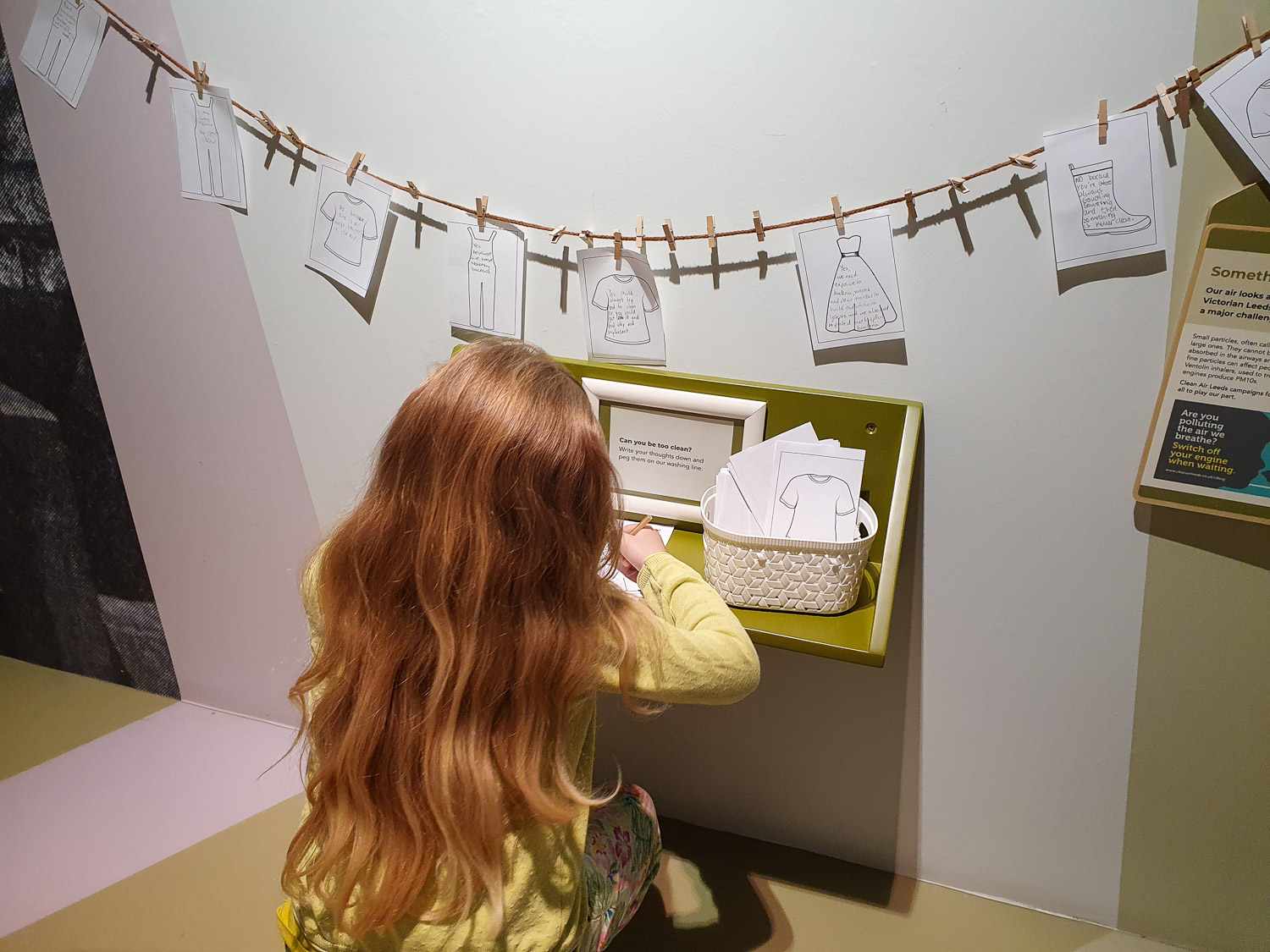 My daughter writing under a line of pegged answer cards, taking on one of the family challenges at the reopened Thackray Museum, Leeds
