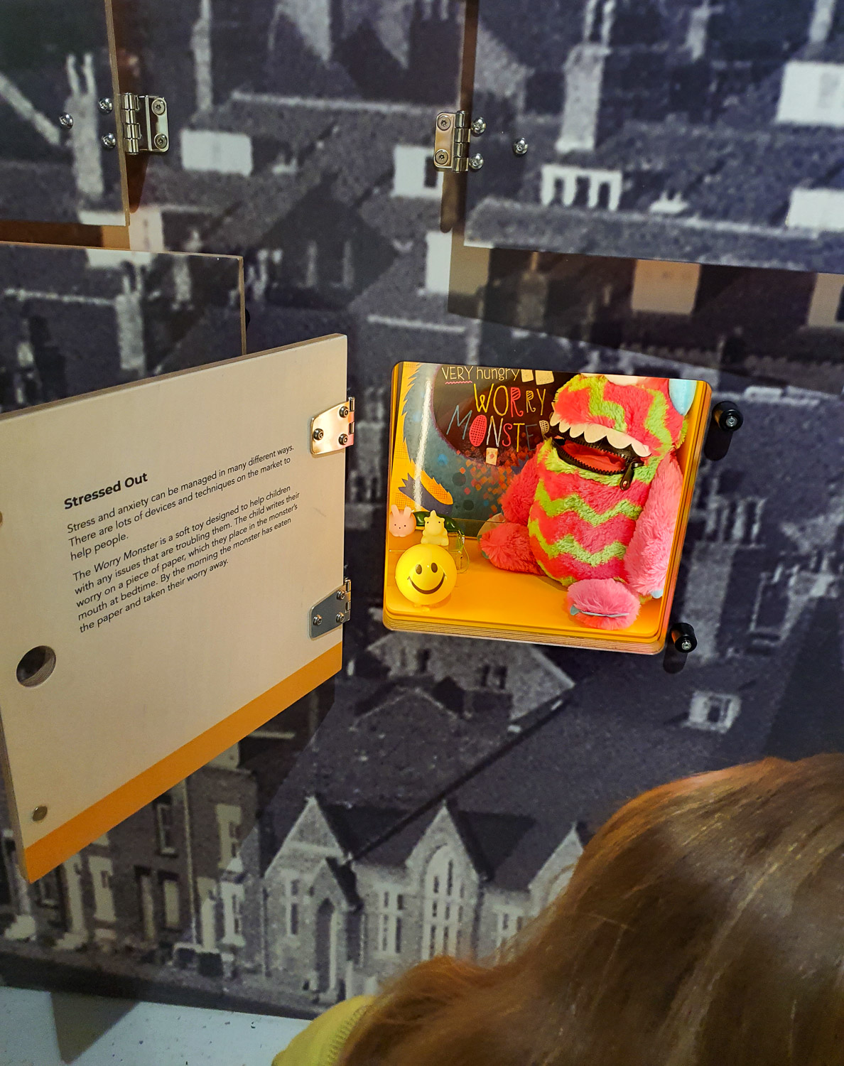 My daughter stands by one of the open boxes in a display at the Thackray Museum, Leeds, showing a worry monster