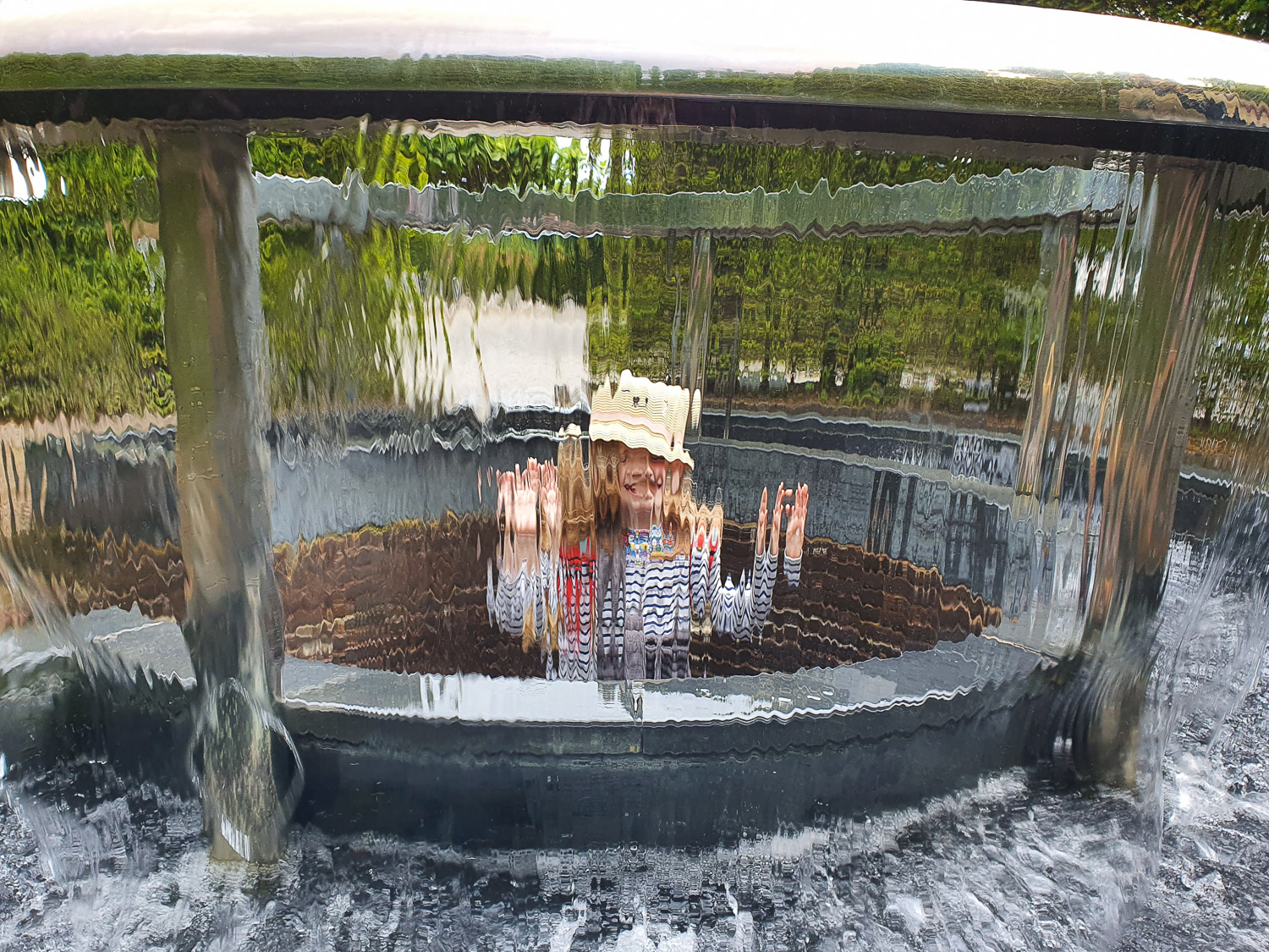 My daughter inside a bubble of water in the Serpent Garden - one of the best parts of a day out at the Alnwick Garden with kids
