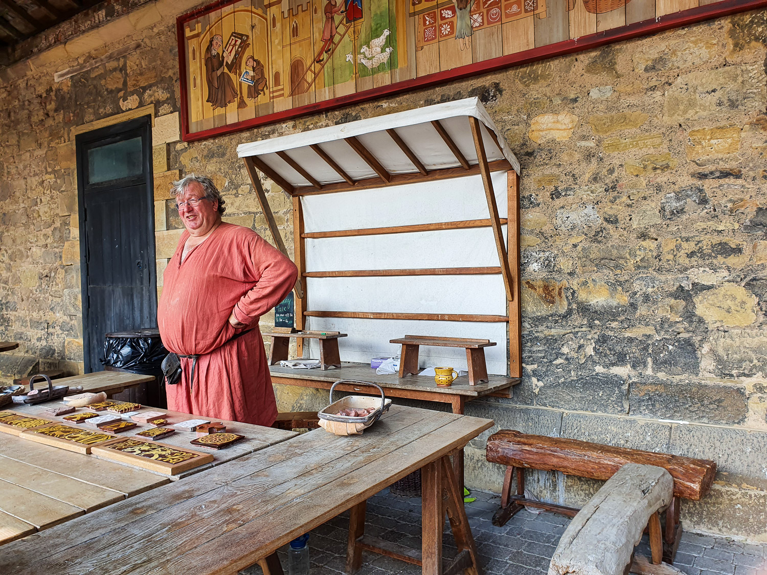 One of the artisans making tiles in the Artisan's Courtyard at Alnwick Castle, Northumberland on a family day out