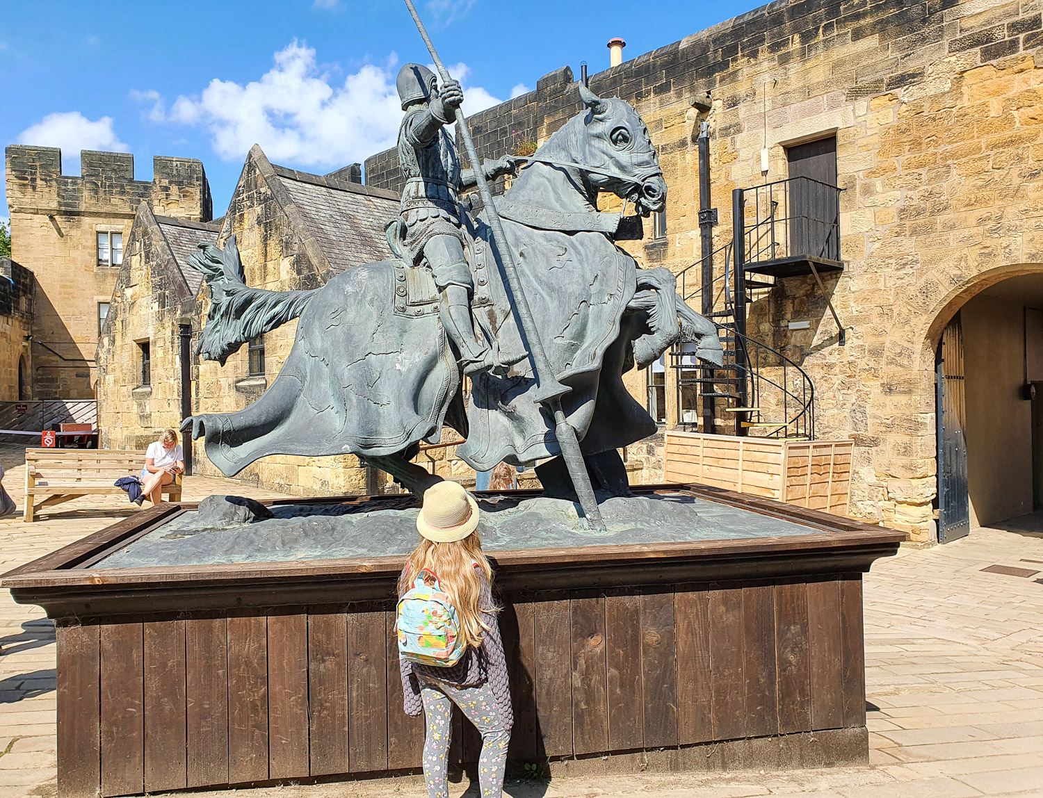 My daughter looks up at the statue of Harry Hotspur, one of the most famous of the Percy family, during a visit to Alnwick Castle with kids