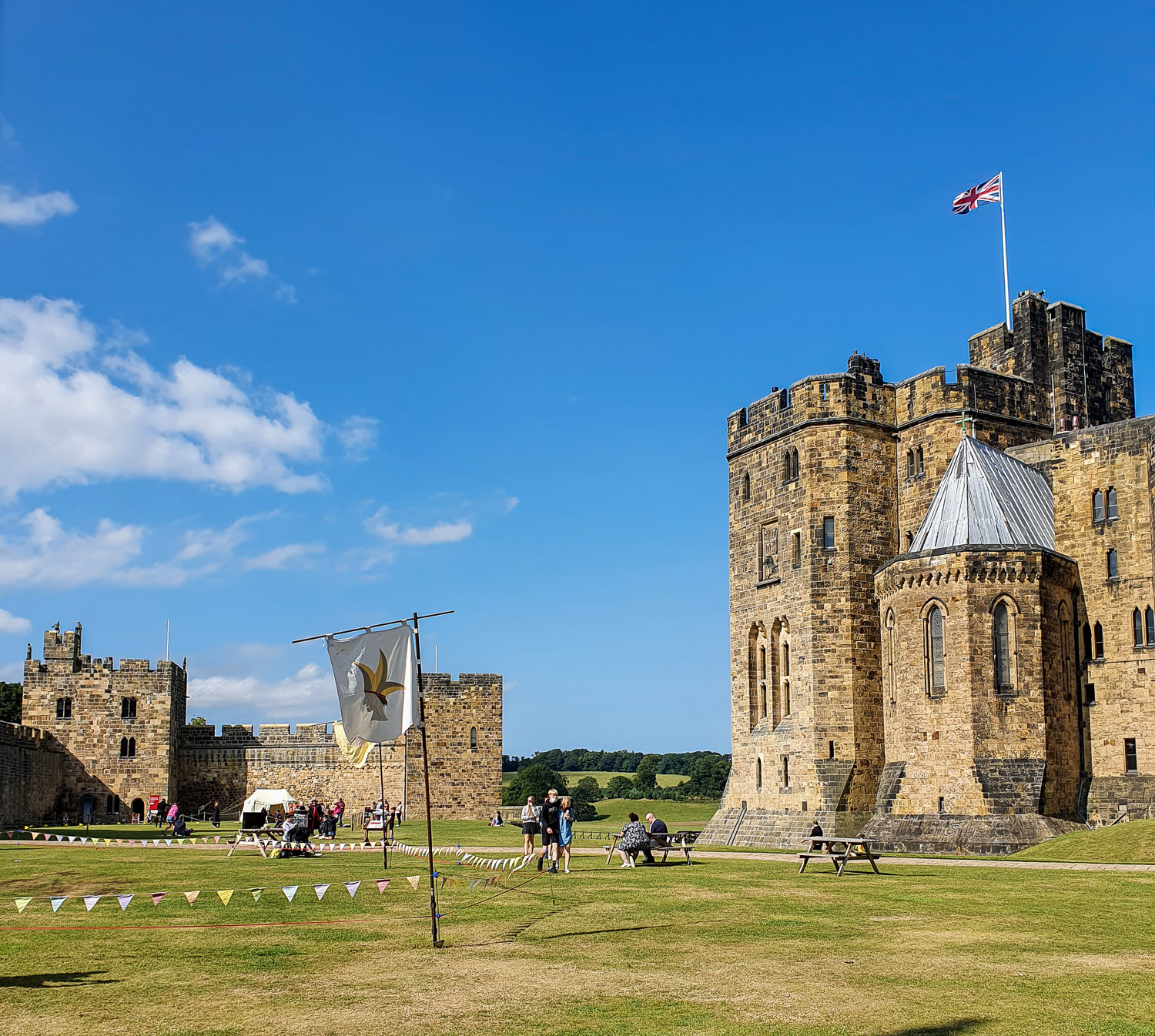 View across the inner bailey and the broomstick lesson area to some of the towers during a visit to Alnwick Castle with kids