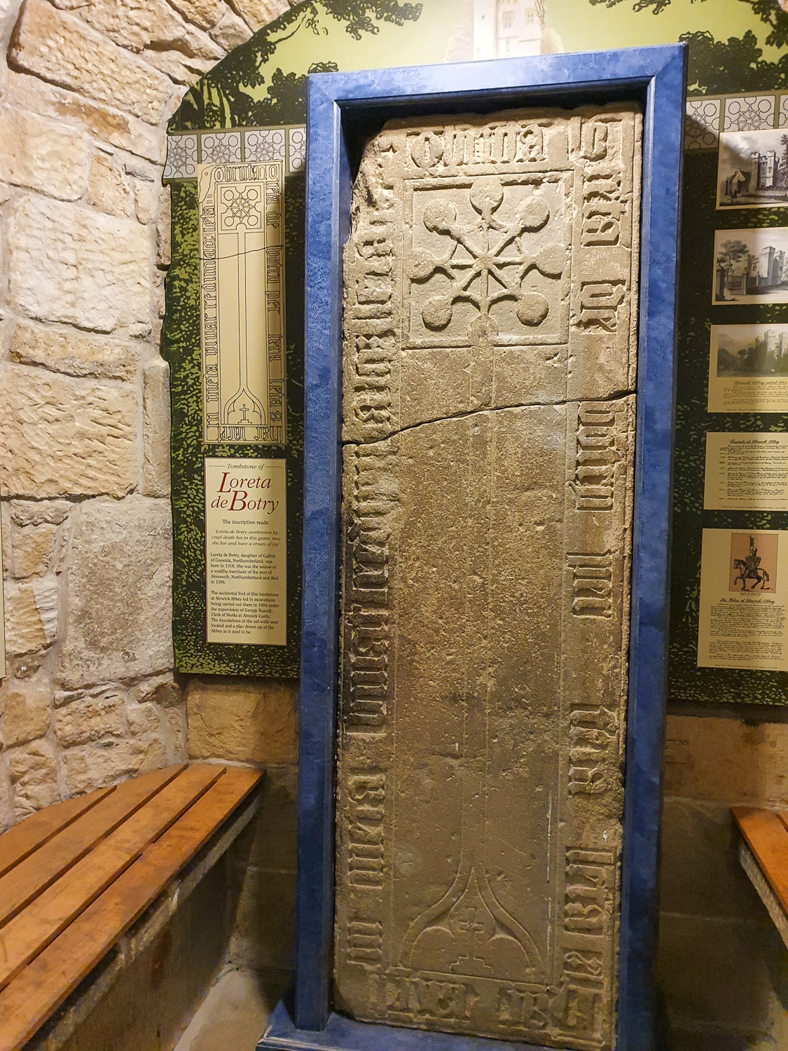 Ancient carved stone tombstone on display in the museum at Alnwick Castle, Northumberland on a family day out