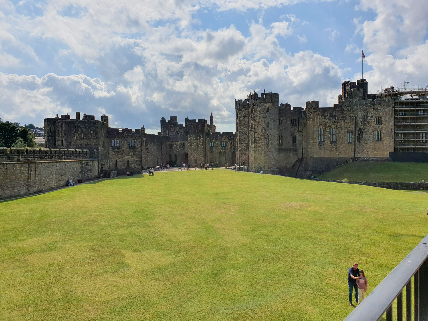 View from the ramparts across the wide open space of the outer bailey during a day out at Alnwick Castle with kids