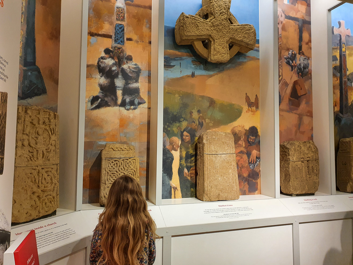My daughter looks at some of the old stone crosses and other remains unearthed at Lindisfarne Priory, during a visit to the small museum on Lindisfarne