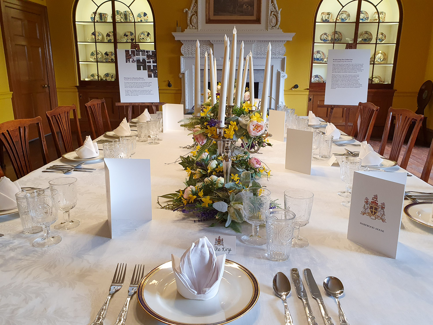 View along the table set for dinner, showing a place card marked 'The King' at Harewood House, stately home in Yorkshire
