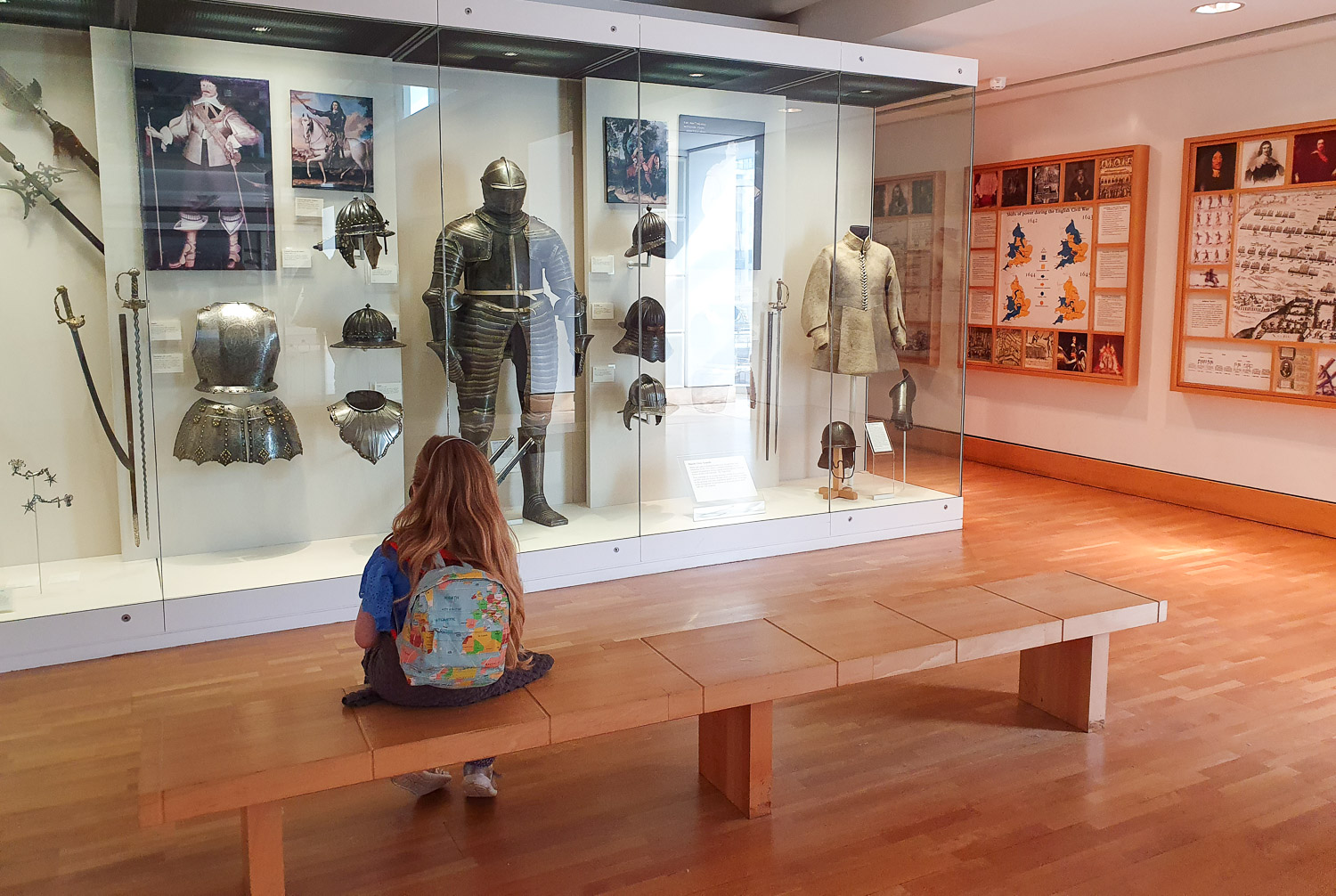 My daughter looks at displays of armour from the time of the English Civil War, including the first bullet proof armour during a visit to the Royal Armouries in Leeds with kids