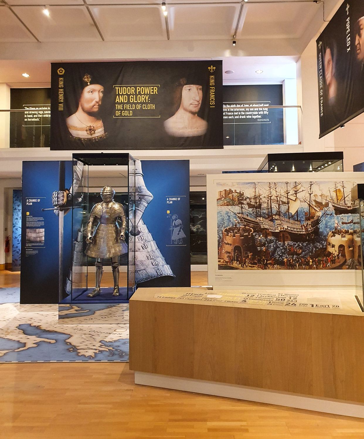 Display from the temporary exhibition on the Field of the Cloth f Gold including armour, picture of a ship and portraits of Henry VIII and Francis I of France, during a visit to the Royal Armouries with kids