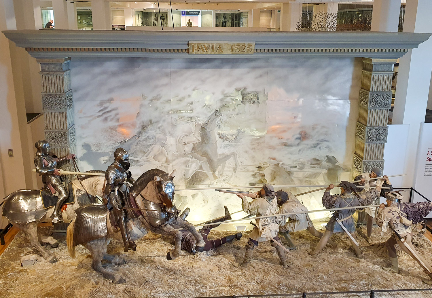 Tableau showing the battle of Pavia with armoured knights on horseback holding lances against unarmoured soldiers with guns - one of the battles depicted in detail during a visit to the Royal Armouries in Leeds