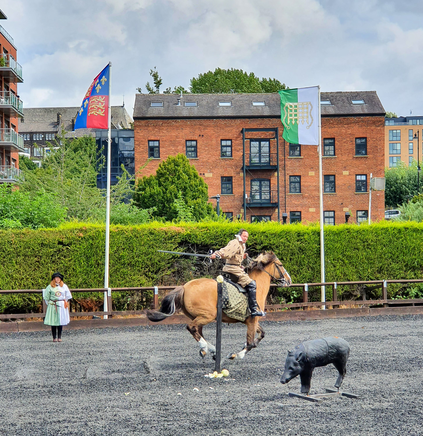 One of the riders slices a cabbage on a post with a sword while on horseback in the tiltyard - the shows are a highlight of visiting the Royal Armouries with kids
