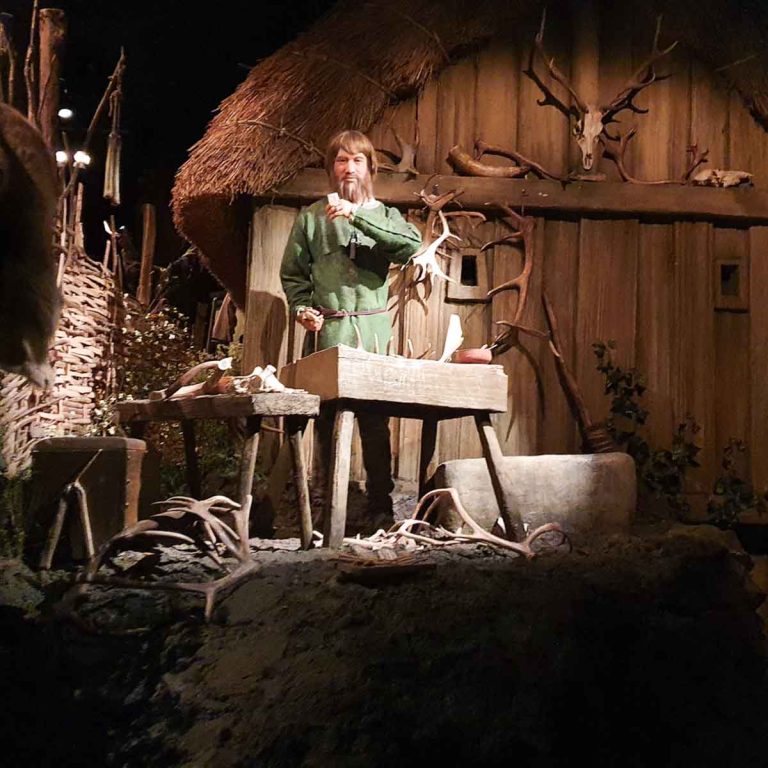 One of the animatronic figures, a Viking carving bone, during a visit to the Jorvik Viking Centre in York with kids