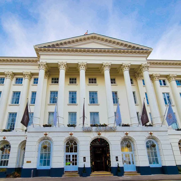 Facade of the Queens hotel in Cheltenham, white Palladian architecture against a blue sky - my base for discovering the best things to do in Cheltenham with kids