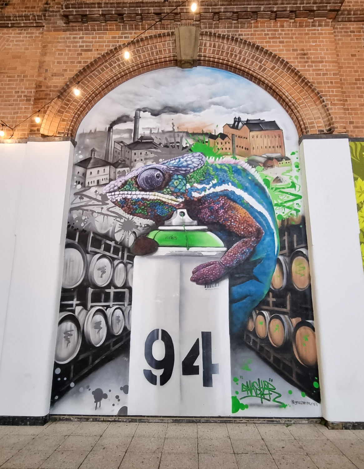Street art showing a chameleon on a spray can in the Brewery Quarter of Cheltenham, one of the unexpected things to see in Cheltenham with kids