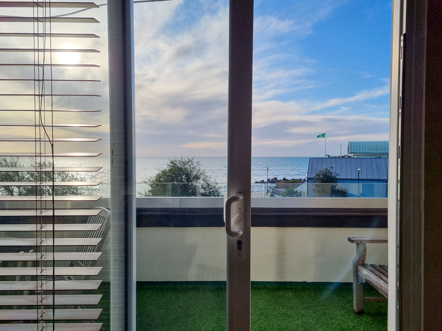 View through the open balcony door to the sea from the penthouse at the Beachcroft hotel Felpham - my review of a stay at the Sussex hotel with kids