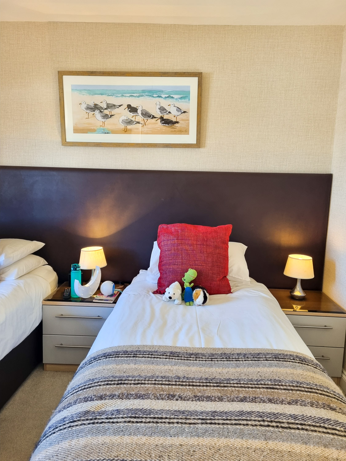 View of soft toys on one of the twin beds under a seagull picture in a bedroom of the penthouse at the Beachcroft hotel Felpham - my review of a stay at the Sussex hotel with kids