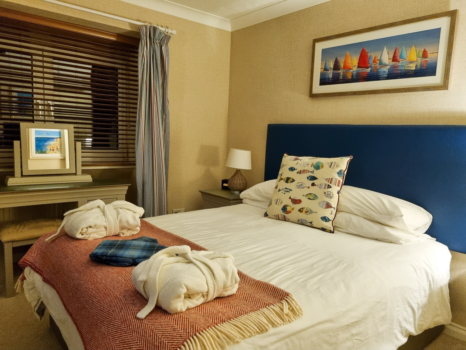 Double bed with robes, hot water bottles and sea themed accessories in the main bedroom of the penthouse at the Beachcroft hotel Felpham - my review of a stay at the Sussex hotel with kids