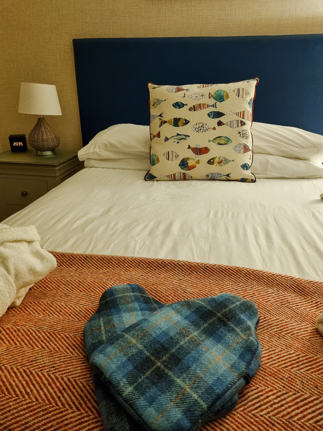 View of two hot water bottles with tartan covers crossed to form a heart on one of the beds in the penthouse at the Beachcroft hotel Felpham - my review of a stay at the Sussex hotel with kids