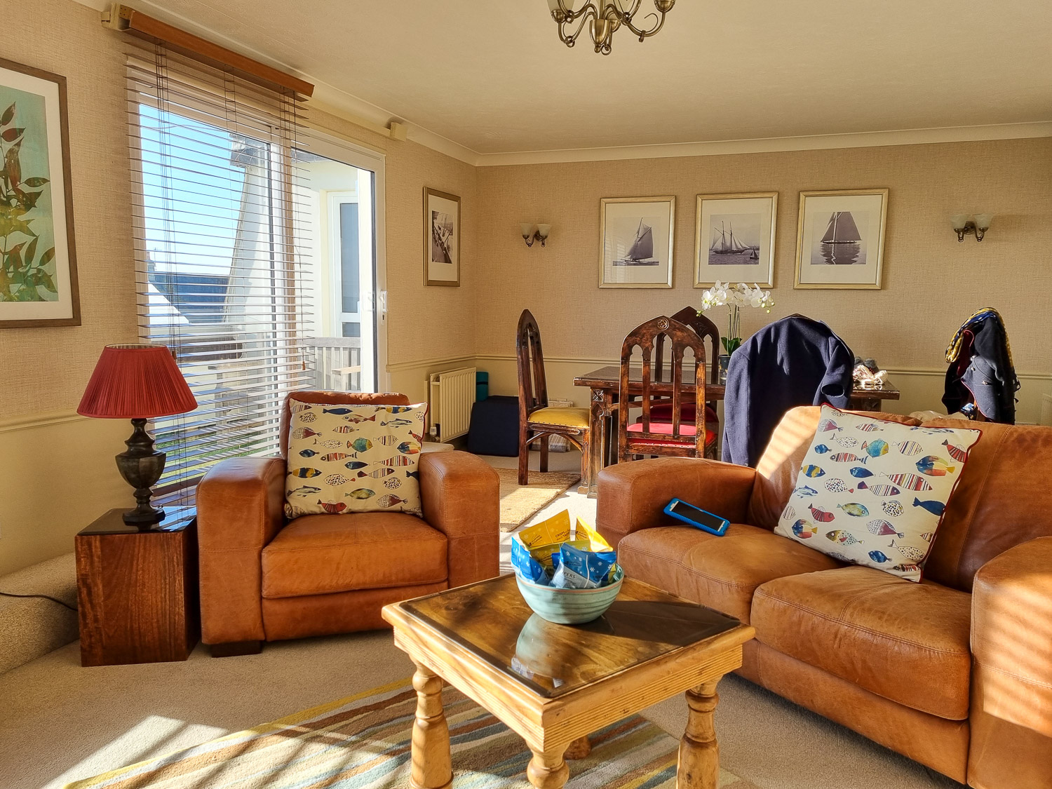 View of the sofa and armchair around a table in the living space, dining table seen behind, of the penthouse at the Beachcroft hotel Felpham - my review of a stay at the Sussex hotel with kids