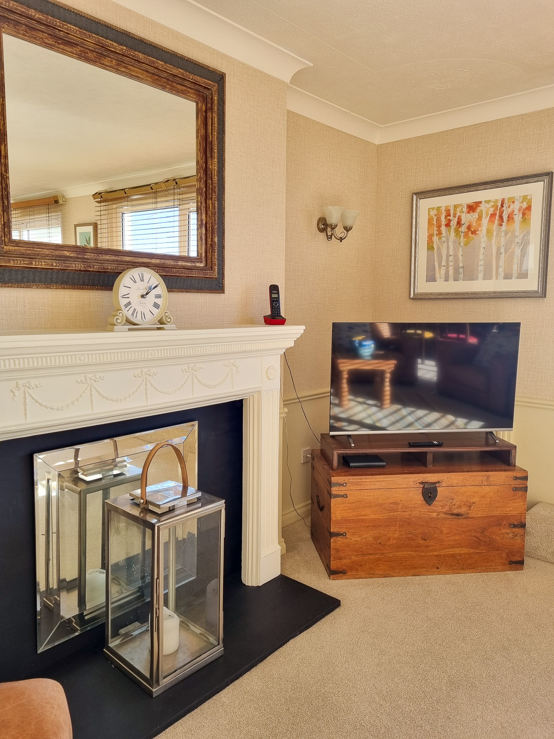 View towards the TV on a wooden chest and fireplace in the penthouse at the Beachcroft hotel Felpham - my review of a stay at the Sussex hotel with kids