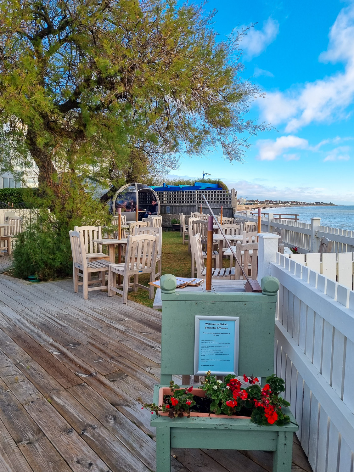 View towards the tables and pod of the beachfront bar at the Beachcroft Hotel in west Sussex near Bognor Regis
