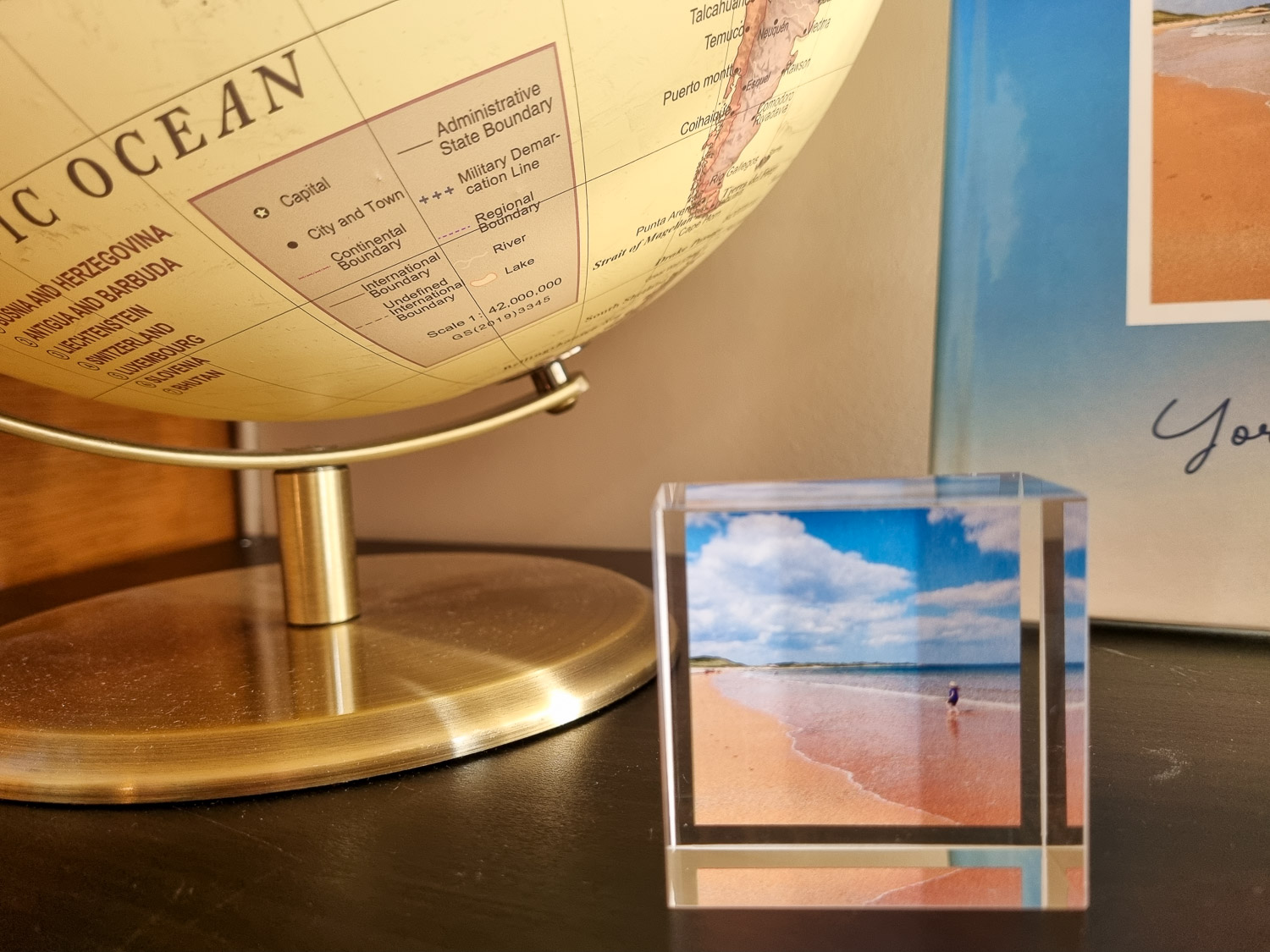 Close-up image of a MixBlox acrylic block showing a girl on a beach, photobook and globe in the background - my review of My Picture photo printing