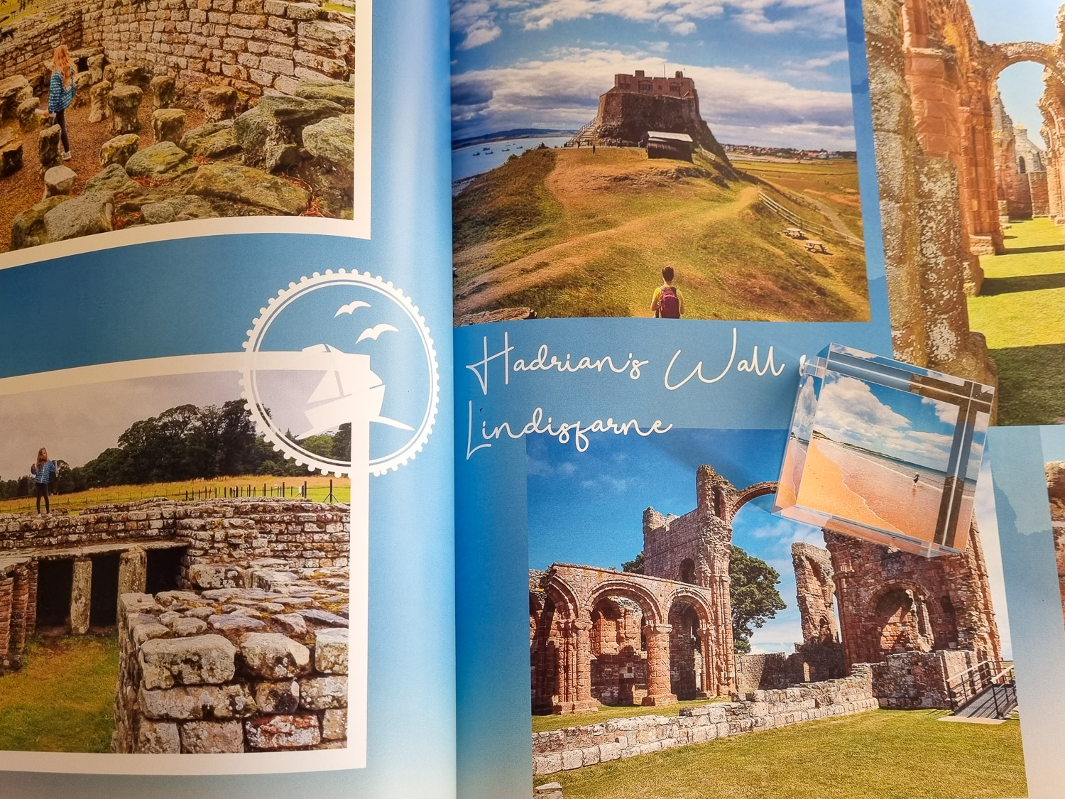 Open photo book showing photos of a family day out on Lindisfarne and Hadrian's Wall in Northumberland, created as part of a review of My Picture photo printing services