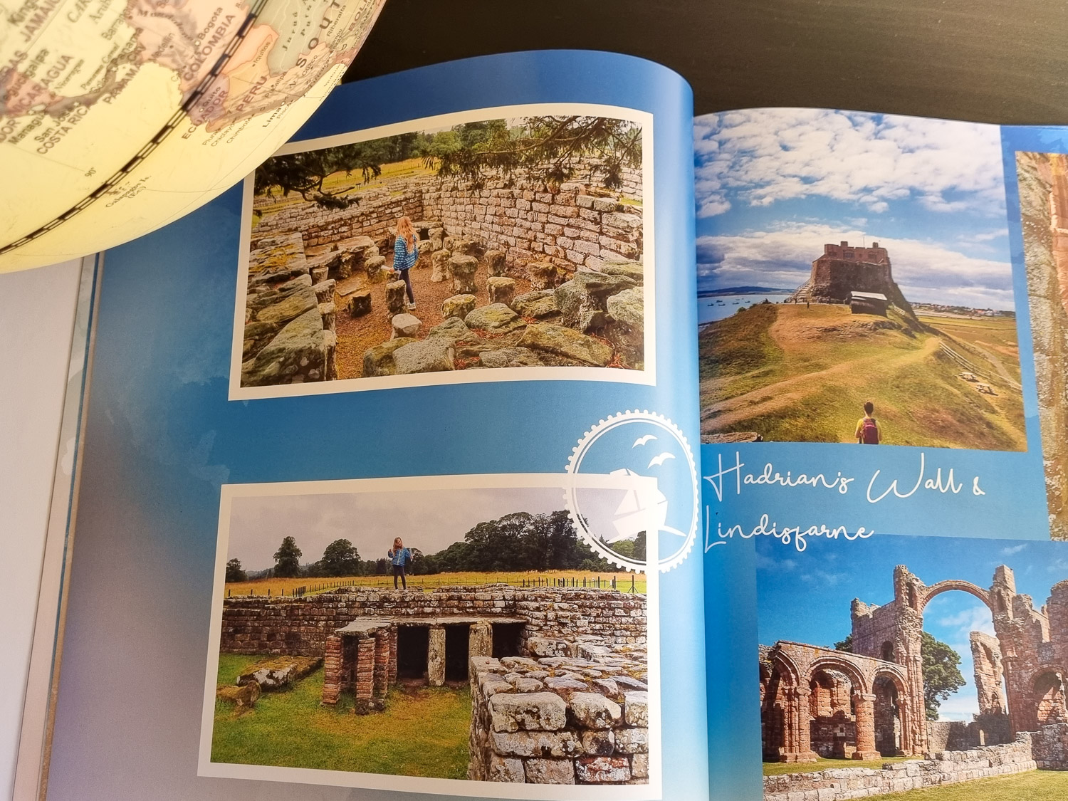 Open photo book showing photos of a family day out at Hadrian's Wall and Lindisfarne in Northumberland, and a globe just seen, created as part of a review of My Picture photo printing services
