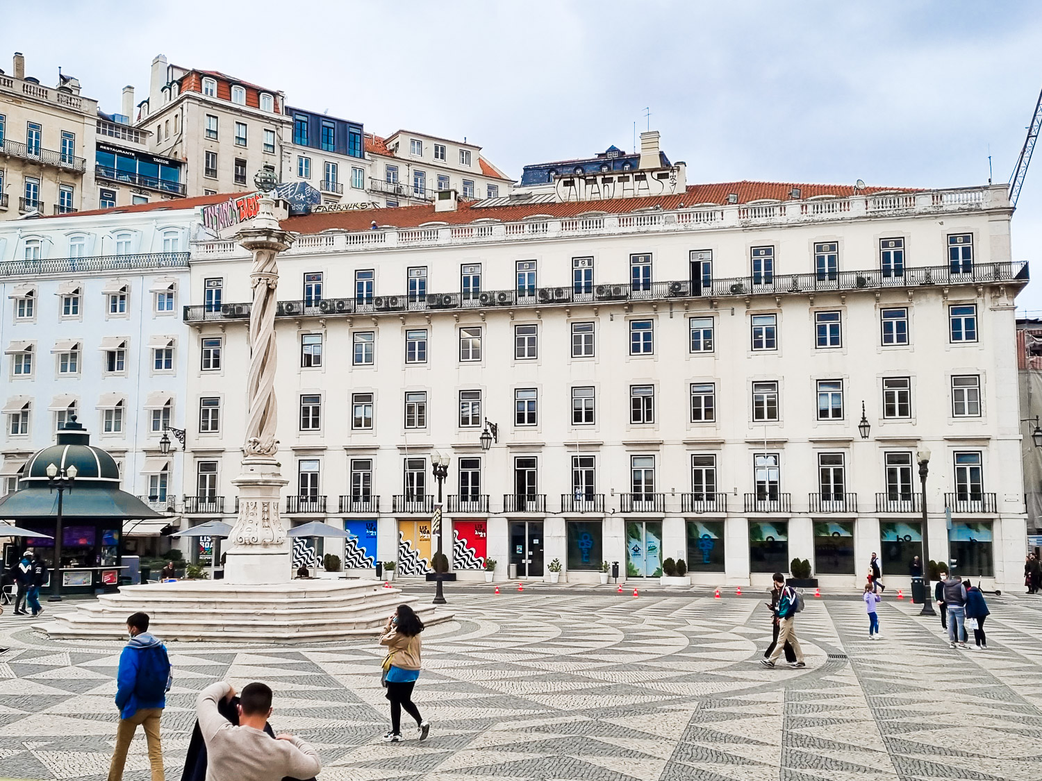 View of Praça do Municipio with its decorative black and white paving, white buildings and twisted column seen from high up in a Hippotrip amphibious vehicle during a boat and bus tour of Lisbon with kids - my review