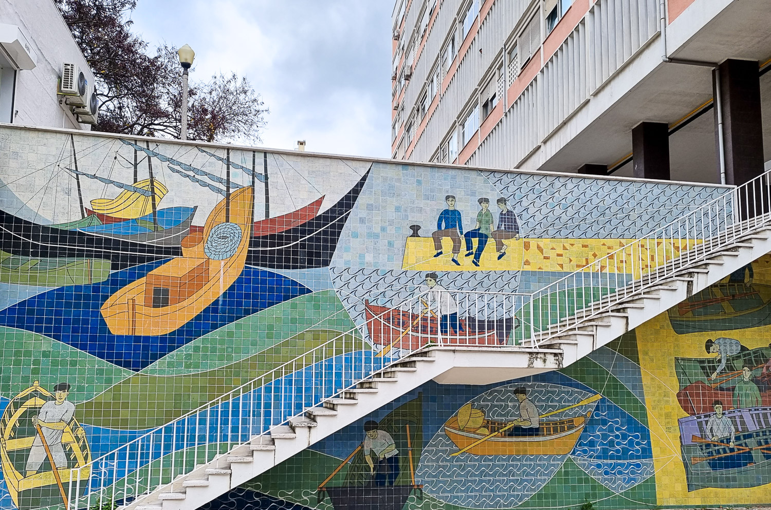 View of decorative tiles showing fishing scenes on the side of a stairway in Lisbon, seen during a Hippotrip tour with kids - my review