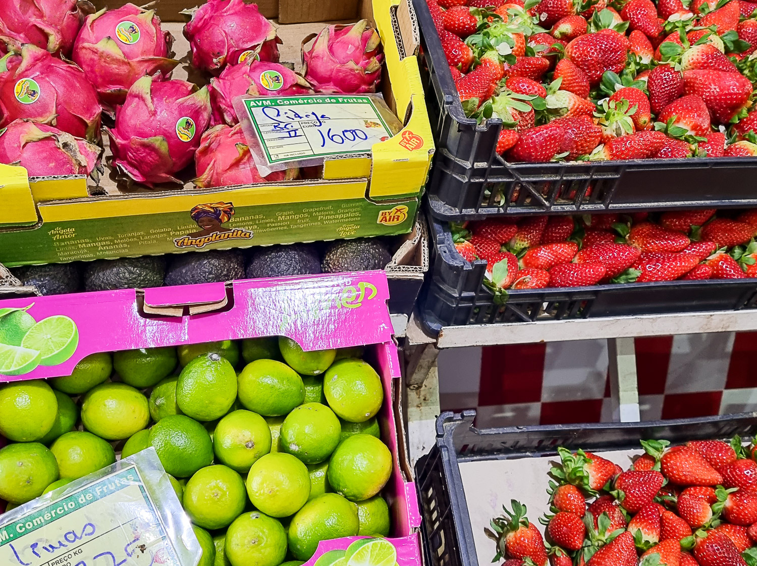 Close-up of some of the fruit on sale at one of Lisbon's markets including dragonfruit, strawberries and limes - my review of a Lisbon cooking class with kids