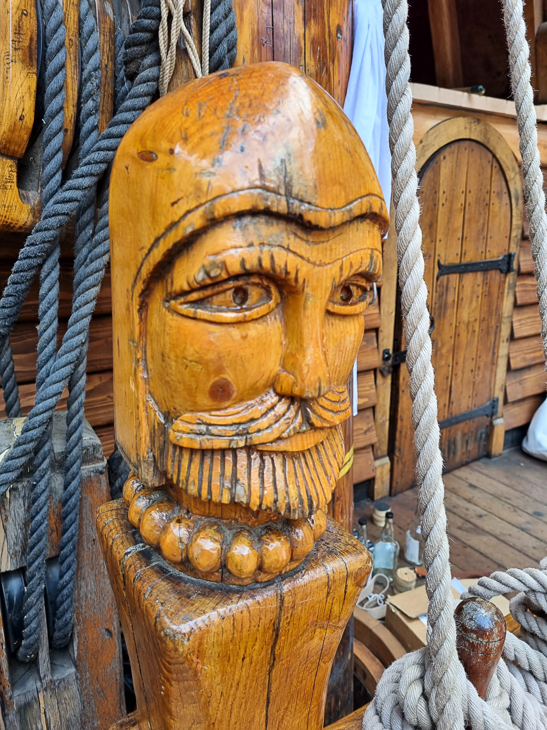 Close-up of a carving of Sir Francis Drake's head on the deck of the Golden Hinde in London - my Escape from the Golden Hinde review of a new escape room in London with kids