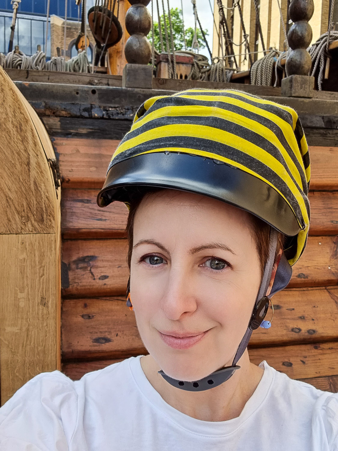 Wearing my protective helmet covered in black and yellow striped material before heading to play the Golden Hinde escape room - my Escape from the Golden Hinde review