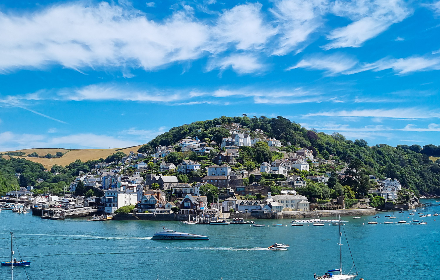 View of boats on the river Dart in Dartmouth, looking out across the water towards Kingswear - one of my favourite places in Devon for a day out, it's an easy drive from Dittisham Hideaway with kids
