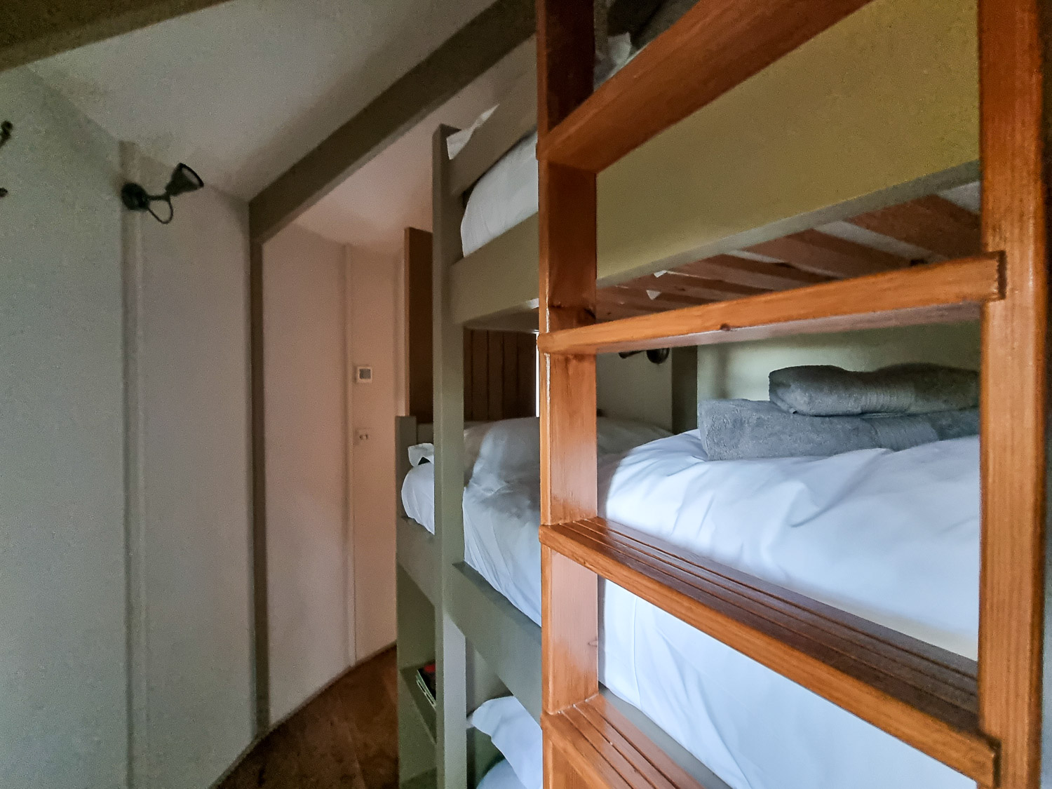 View along the side of the triple bunk beds in Owl Treehouse - my review of Dittisham Hideaway with kids