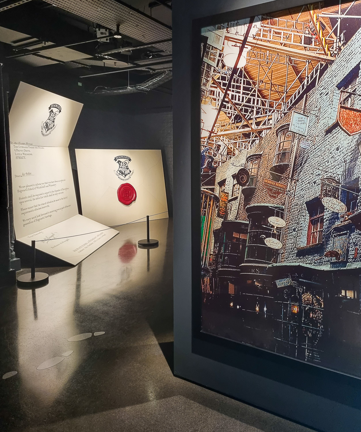Entrance to London's Harry Potter Photo Exhibition including giant Hogwarts acceptance letter and set of Diagon Alley - my review of a visit with kids