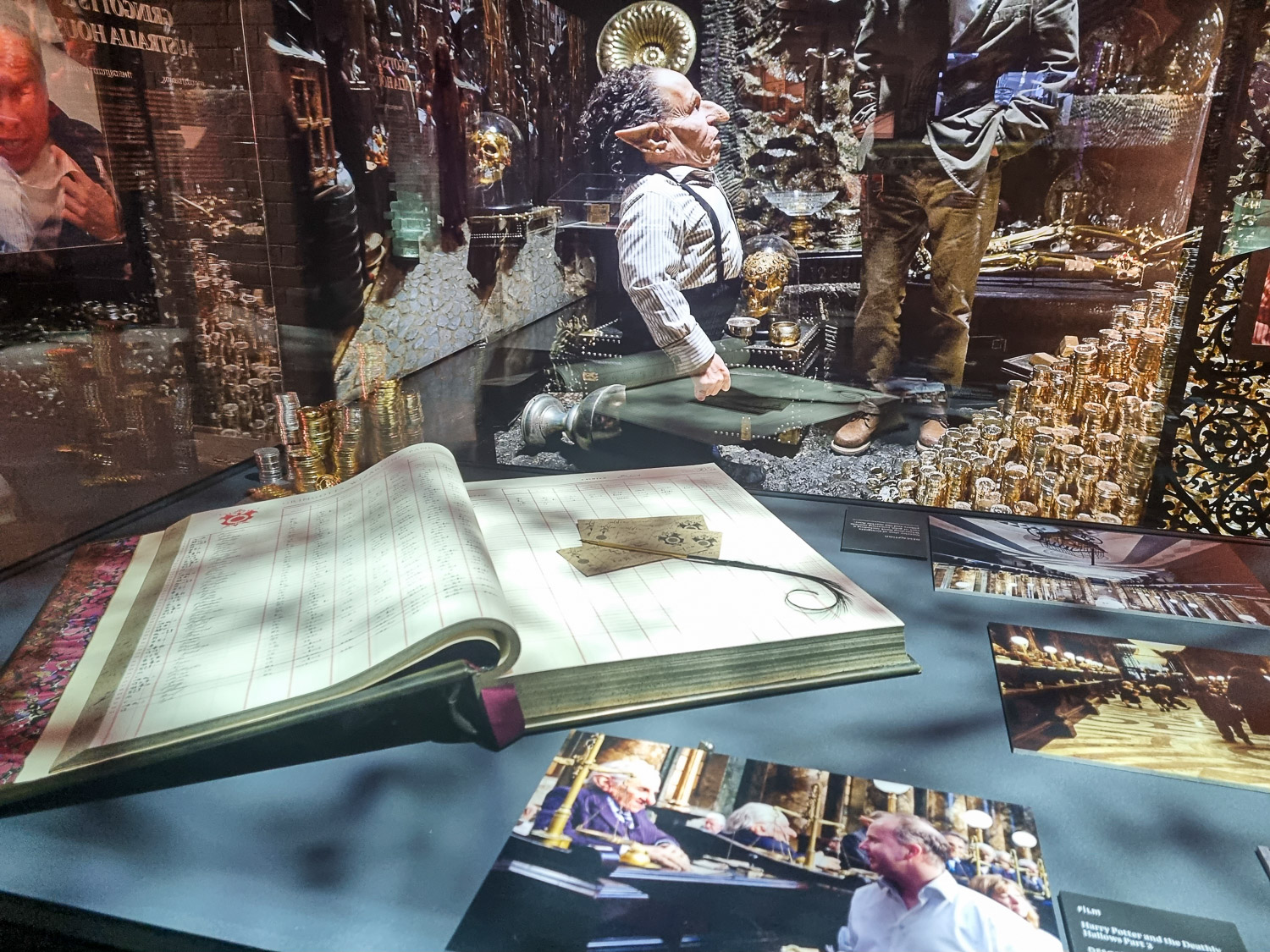 Close-up of photos of filming including goblins and some of the props from Gringotts during a visit to London's Harry Potter Photographic Exhibition with kids