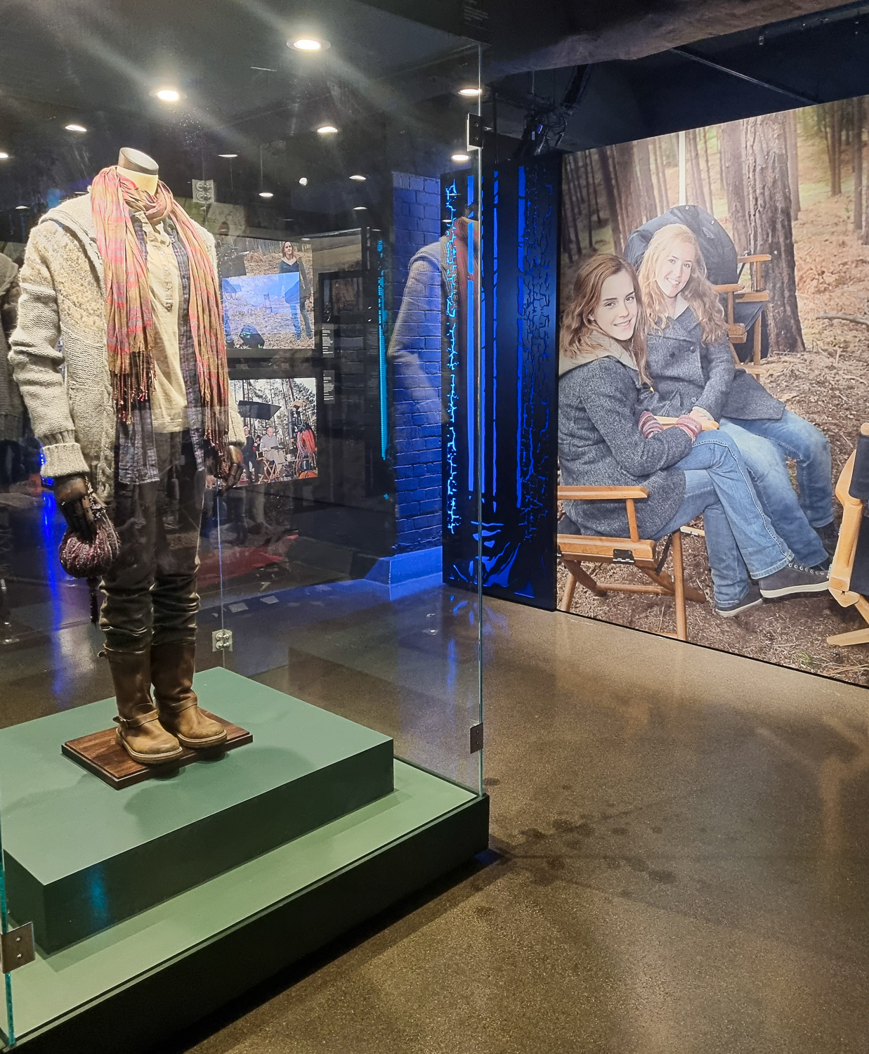 Outfit worn by Emma Watson playing Hermione Granger and photo of her with stunt doubles on display during a visit to London's Harry Potter Photo Exhibition with kids